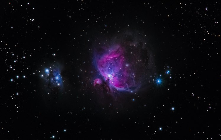 Image of stars and a purple nebula in the center.